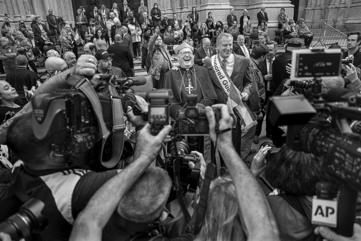 Photographers gathered around parade participants on Fifth Avenue, photographed by Steve Simon
