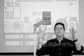 Steve Simon teaching in front of a projected camera-settings display, photographed in black and white.