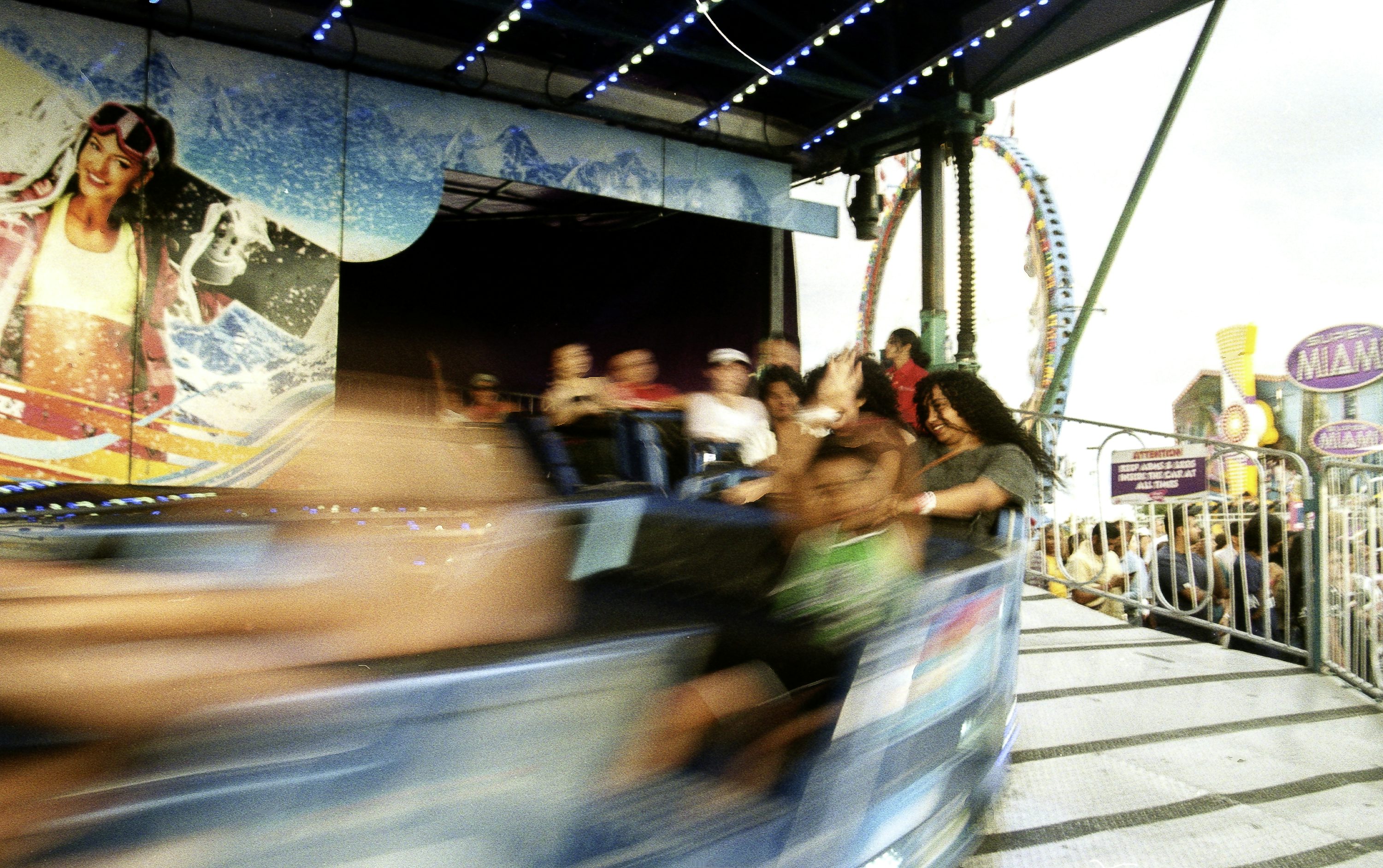 People riding a spinning carnival attraction at the Canadian National Exhibition in Toronto